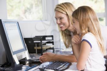 Royalty Free Photo of a Woman and Daughter at the Computer