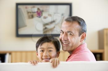 Royalty Free Photo of a Father and Son Watching Television