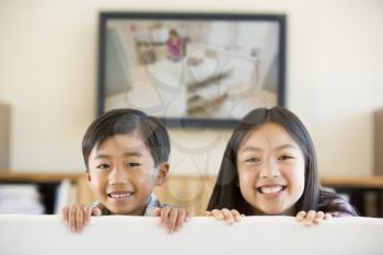 Royalty Free Photo of Two Children in Front of a Television
