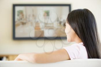 Royalty Free Photo of a Young Girl Watching Television