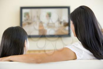 Royalty Free Photo of a Woman and Daughter Watching Television