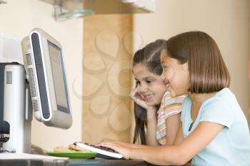 Royalty Free Photo of Two Girls at a Computer