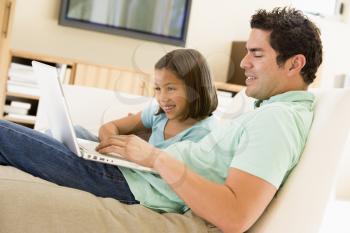 Royalty Free Photo of a Father With His Daughter and a Laptop
