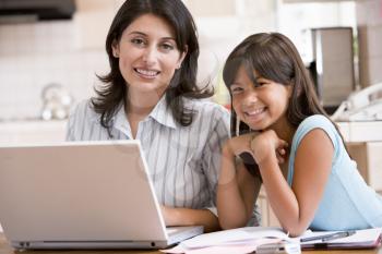 Royalty Free Photo of a Woman and Her Daughter at a Laptop