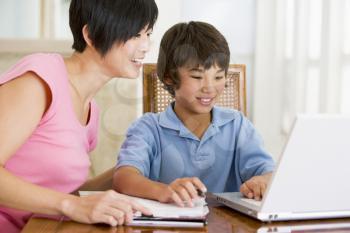 Royalty Free Photo of a Mother Helping Her Son With Homework
