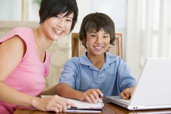 Royalty Free Photo of a Mother Helping Her Son With Homework