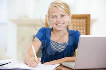 Royalty Free Photo of a Smiling Girl Doing Homework