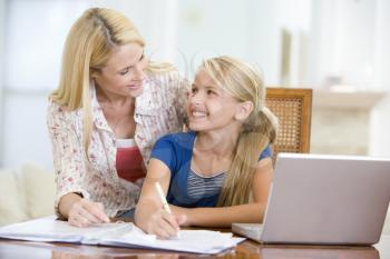 Royalty Free Photo of a Mother Helping Her Daughter With Homework