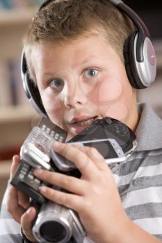 Royalty Free Photo of a Boy With Many Electronic Devices