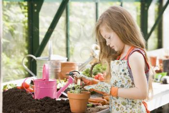 Royalty Free Photo of a Young Girl In a Greenhouse