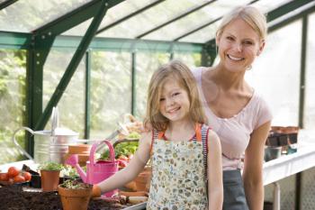 Royalty Free Photo of a Woman and Girl in a Greenhouse
