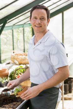 Royalty Free Photo of a Man in a Greenhouse