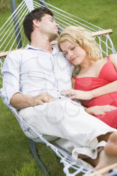 Royalty Free Photo of a Couple Asleep in a Hammock