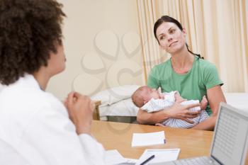 Royalty Free Photo of a Doctor and Patient Holding a Baby