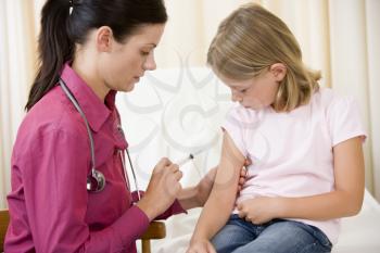 Royalty Free Photo of a Doctor Giving a Little Girl a Needle