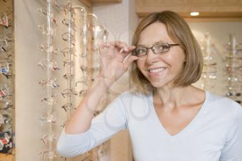 Royalty Free Photo of a Woman Trying on Glasses