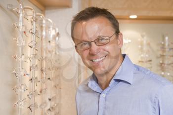 Royalty Free Photo of a Man Trying on Glasses