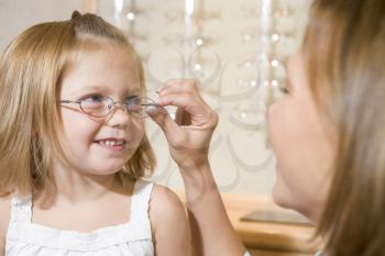 Royalty Free Photo of a Little Girl Trying on Glasses