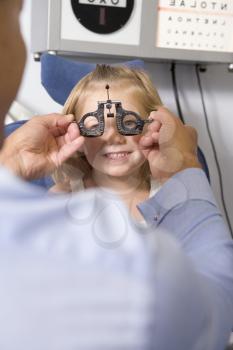 Royalty Free Photo of a Girl Having an Eye Exam