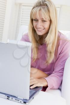 Royalty Free Photo of a Woman on a Patio With a Laptop
