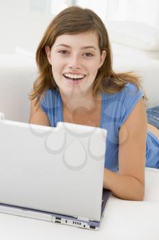 Royalty Free Photo of a Woman Lying on the Couch With a Laptop