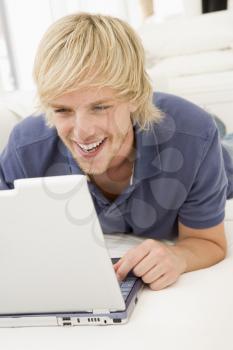 Royalty Free Photo of a Man on a Couch With a Laptop