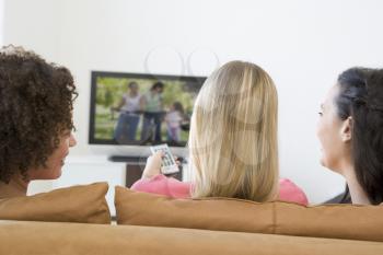 Royalty Free Photo of Three Women Watching Television