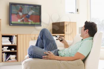 Royalty Free Photo of a Man Watching Soccer on Tv