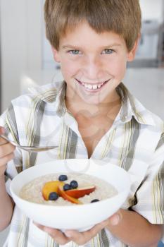 Royalty Free Photo of a Young Boy Eating Oatmeal