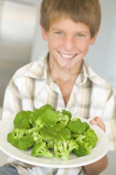 Royalty Free Photo of a Boy With a Plate of Broccoli