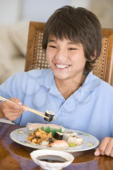 Royalty Free Photo of a Boy Eating Sushi