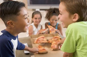 Royalty Free Photo of Children Eating Pizza