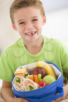 Royalty Free Photo of a Boy With a Lunch Box