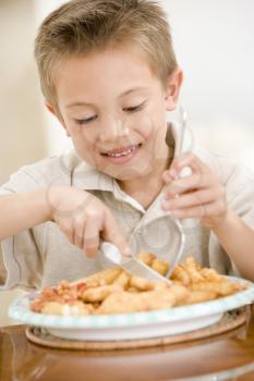 Royalty Free Photo of a Boy Eating Fish and Chips
