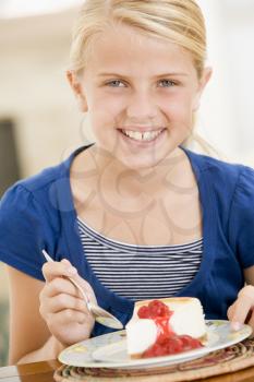 Royalty Free Photo of a Girl Eating Cheesecake