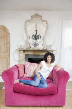 Royalty Free Photo of a Woman Sitting in a Big Chair