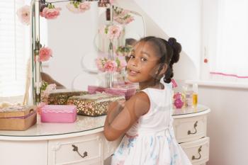 Royalty Free Photo of a Little Girl at a Vanity Mirror
