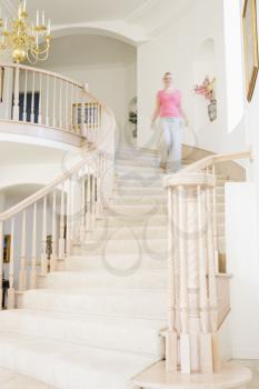 Royalty Free Photo of a Woman Coming Down a Staircase