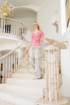 Royalty Free Photo of a Woman Coming Down a Staircase