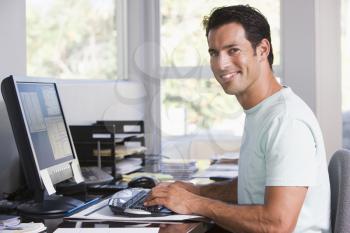 Royalty Free Photo of a Man on a Computer at Home