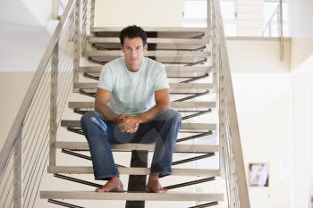Royalty Free Photo of a Man Sitting on a Staircase
