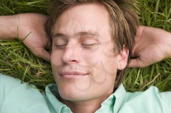 Royalty Free Photo of a Man Sleeping on the Grass