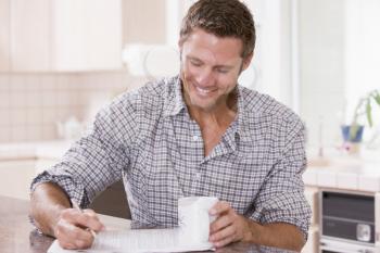 Royalty Free Photo of a Man With a Newspaper and Coffee