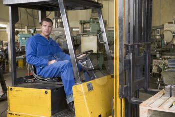 Royalty Free Photo of a Warehouse Worker in a Forklift