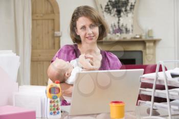Royalty Free Photo of a Mother and Baby in a Home Office
