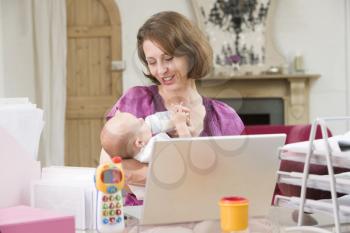 Royalty Free Photo of a Mother and Baby in a Home Office