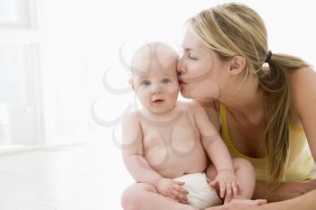 Royalty Free Photo of a Mother Kissing Her Baby