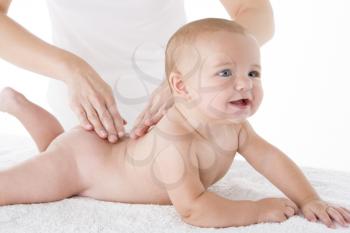 Royalty Free Photo of a Mother Massaging a Baby