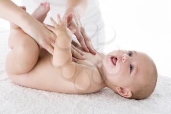 Royalty Free Photo of a Mother Massaging a Baby