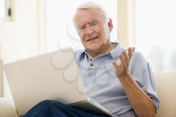 Royalty Free Photo of a Man With a Laptop Looking Frustrated